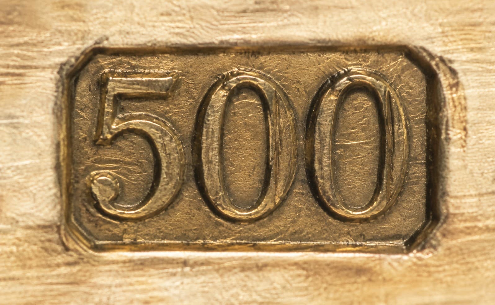 Macro shot of a "500" fineness stamp engraved on gold jewelry