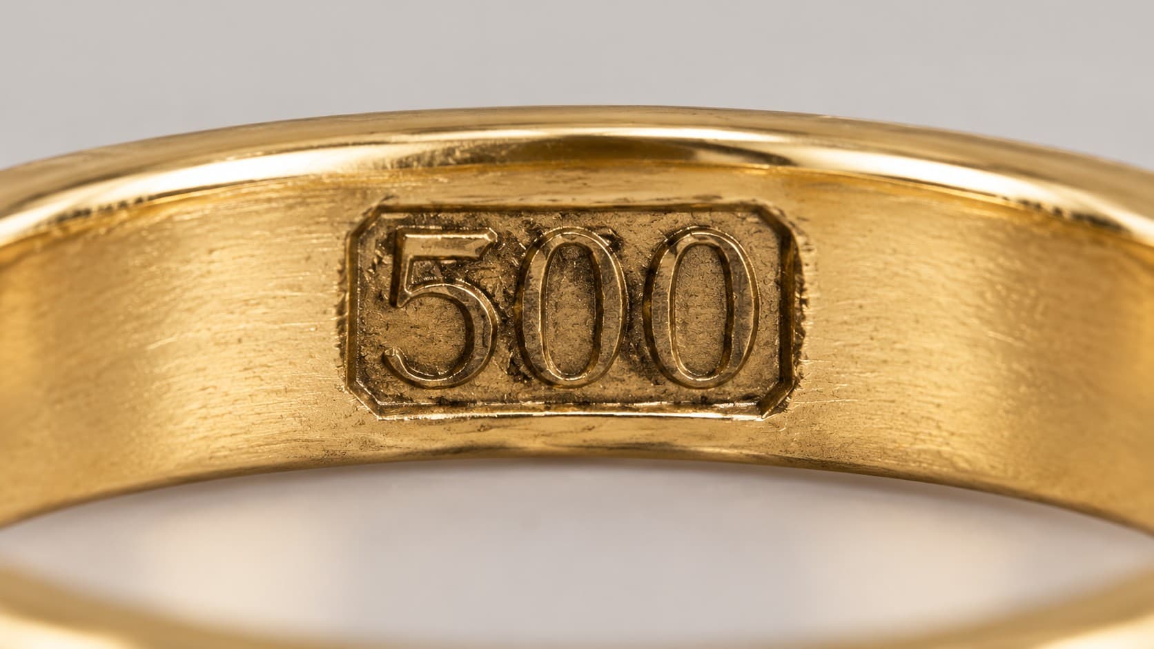 Close-up of a 500 purity stamp inside a 12K gold ring band