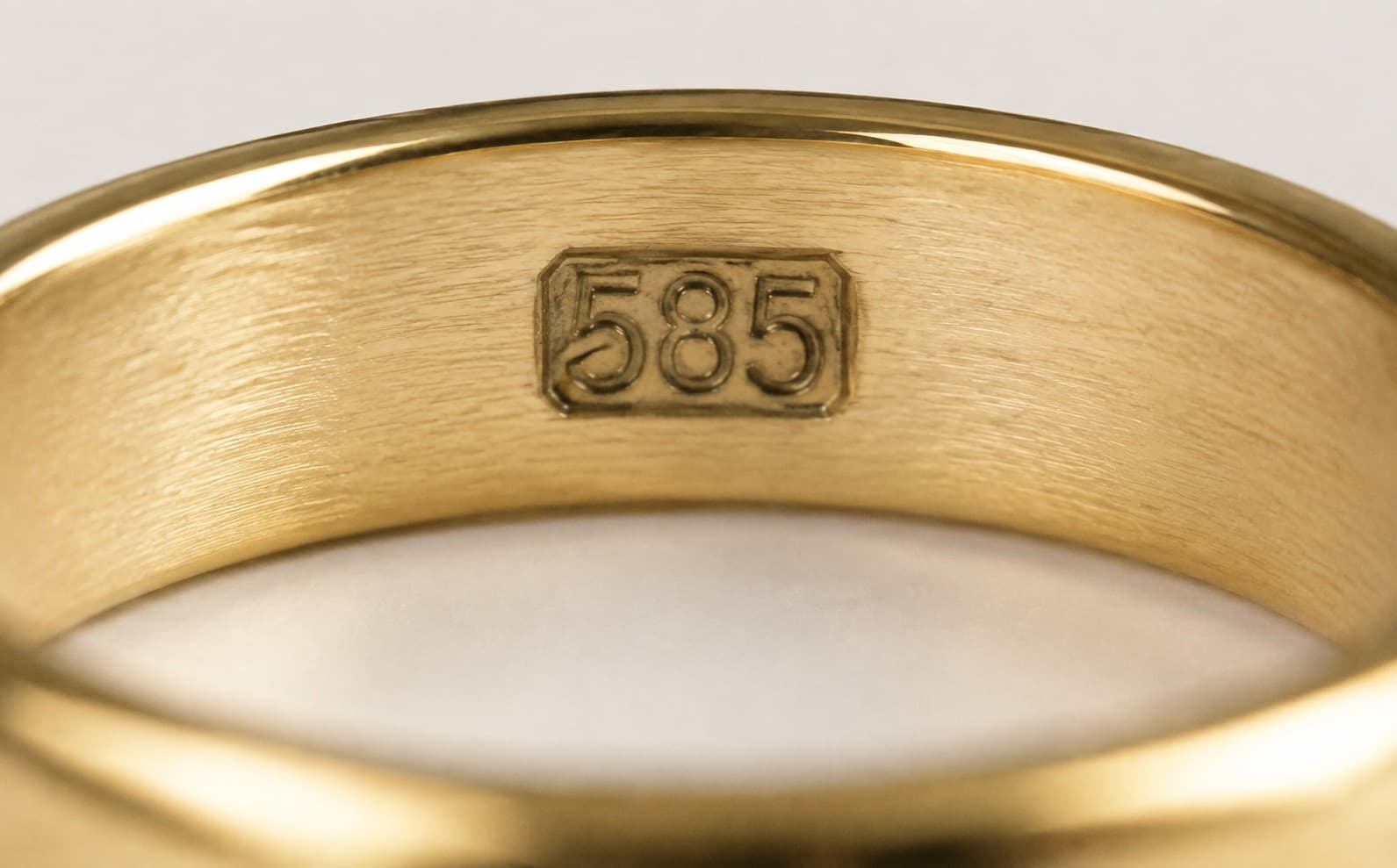 Close-up of a 585 stamp inside a gold ring, marking 14K gold purity
