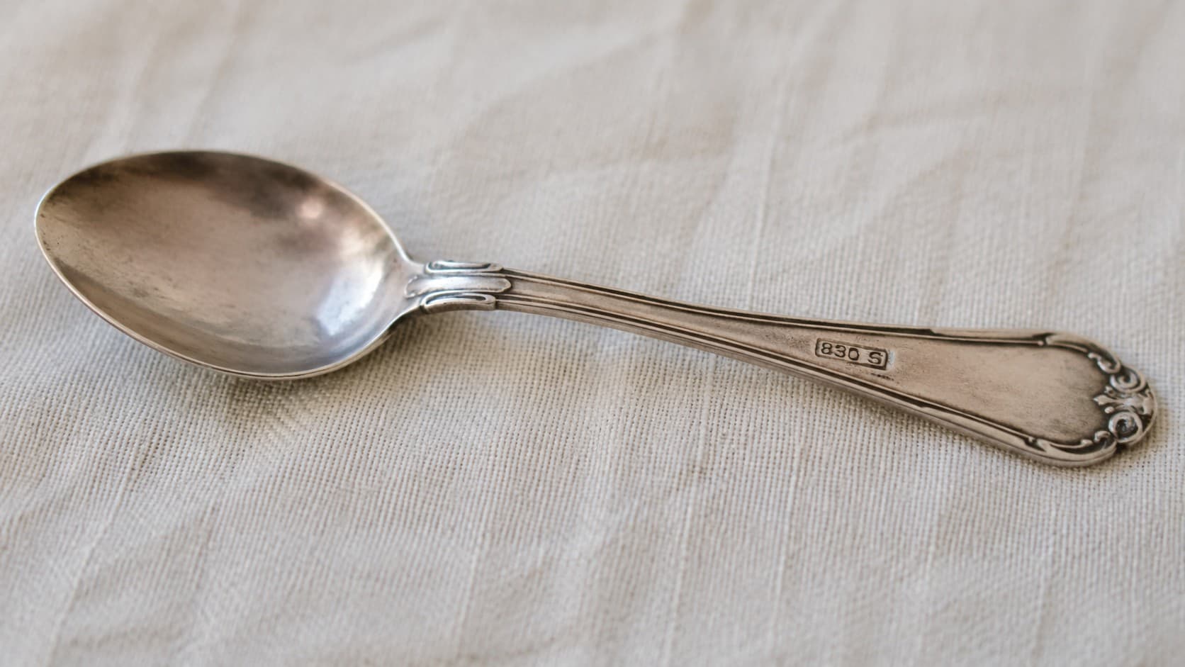 Antique silver spoon with an 830 S purity stamp on the handle