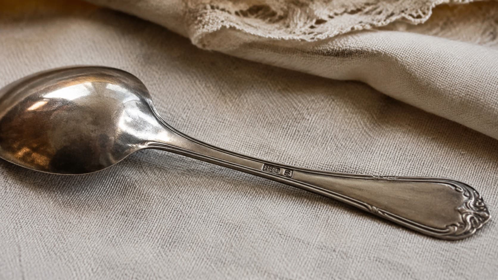 Close-up of an 830 S hallmark stamped on a vintage silver spoon