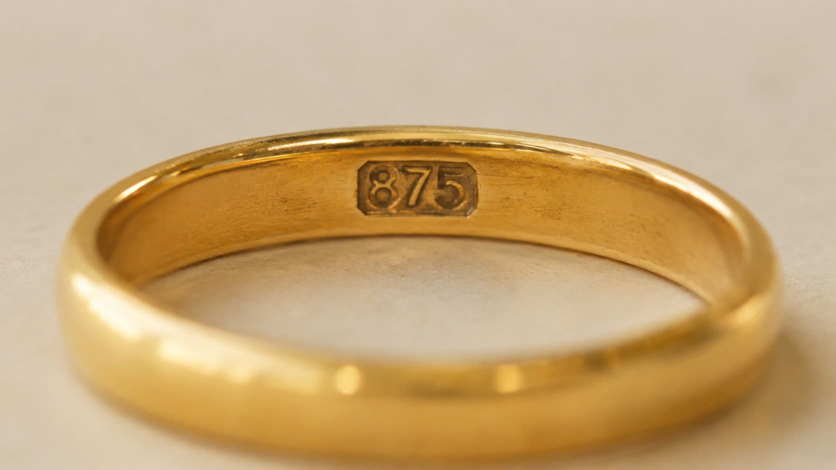 875 stamp engraved inside a gold ring band showing 21K purity mark