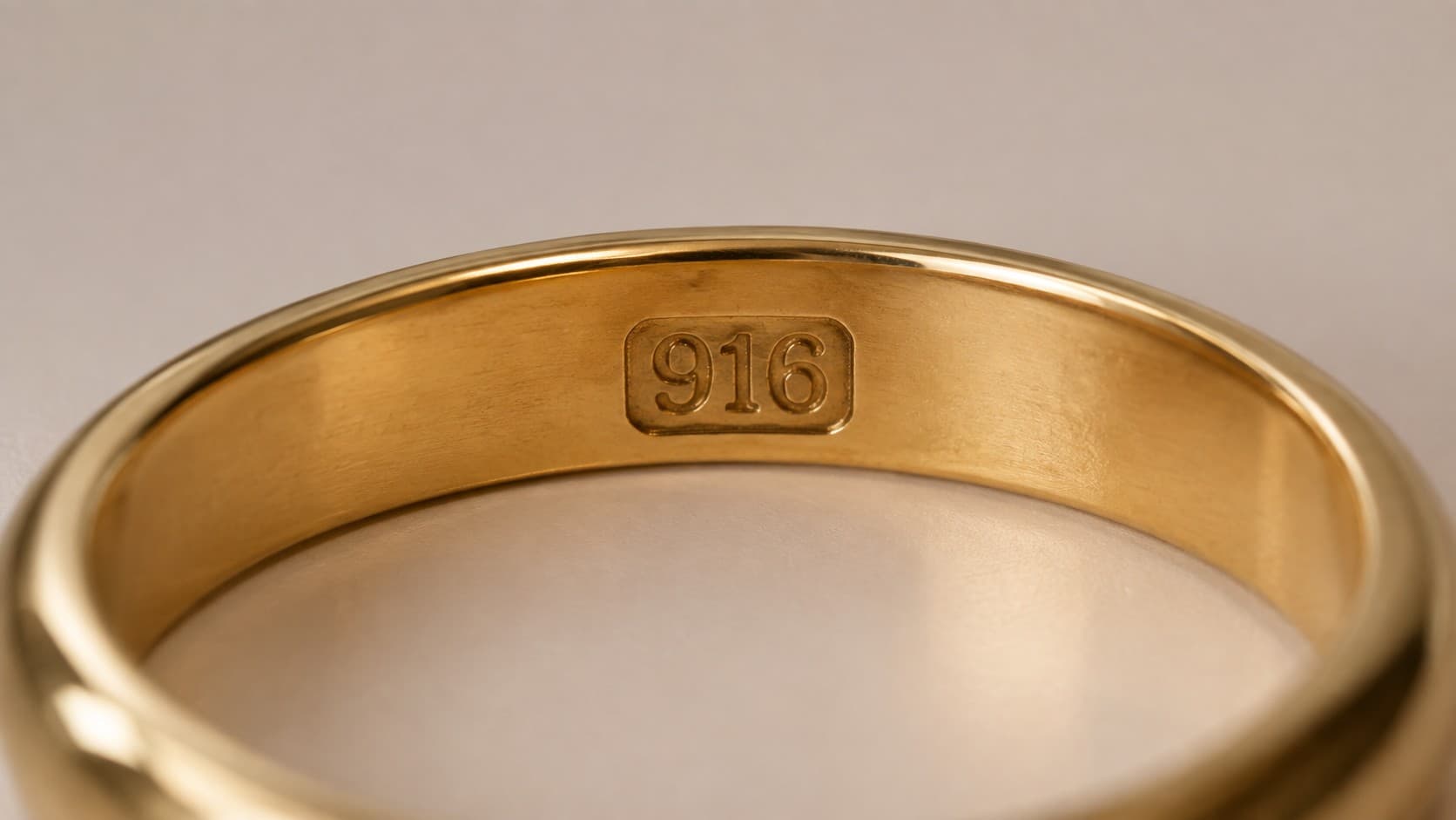 Macro shot of a 916 hallmark stamped inside a gold ring