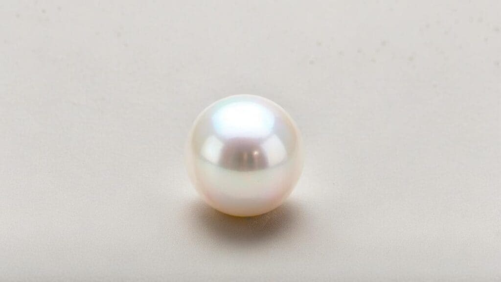 Round white Akoya pearl displaying classic spherical shape and high luster characteristic of saltwater pearls