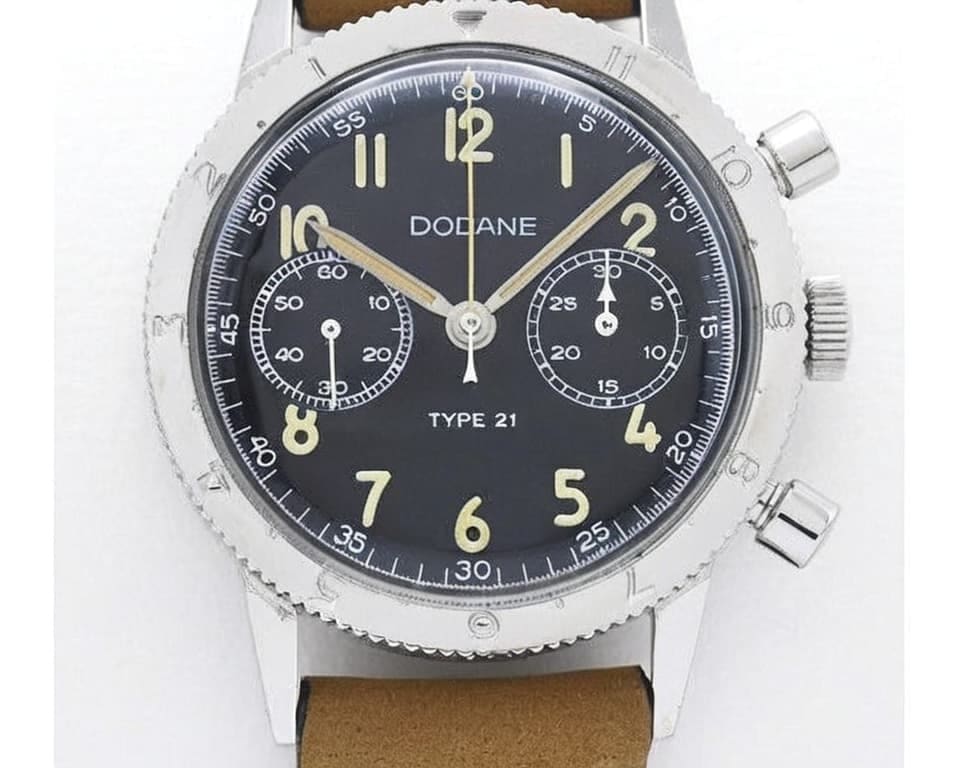 Vintage Dodane Type 21 military pilot chronograph with black dial, large luminous Arabic numerals, bi-compax layout, and tan leather strap