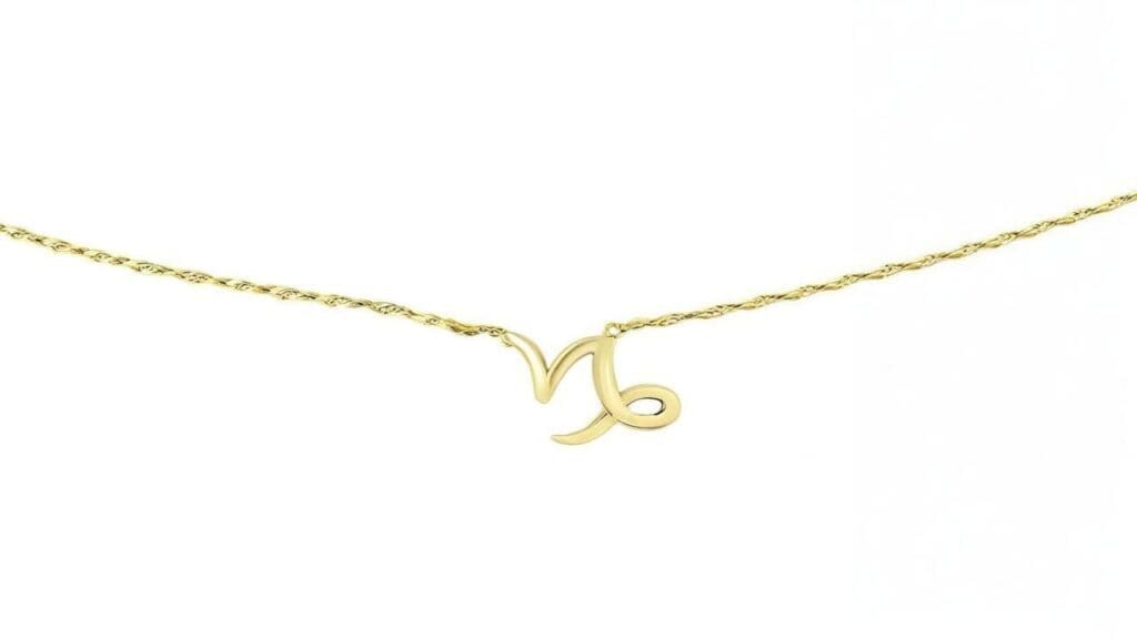 Gold Capricorn glyph necklace featuring the zodiac symbol on a delicate chain.