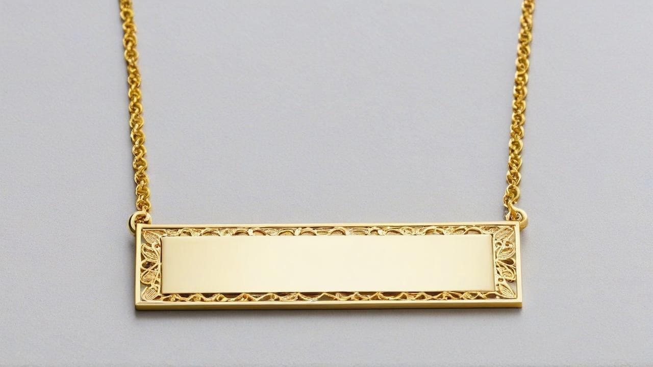 Gold bar nameplate necklace with an ornate filigree border, blank for engraving