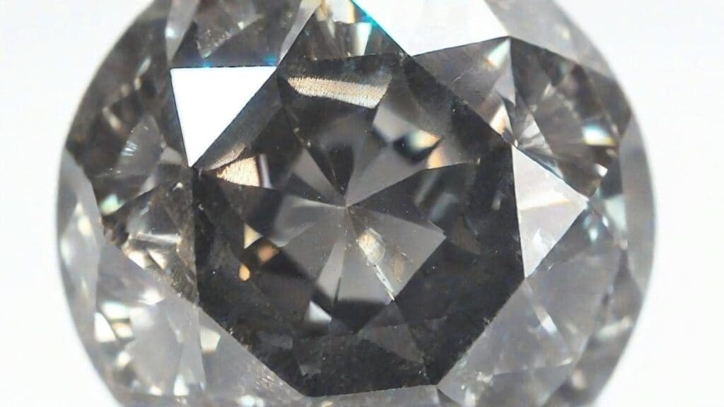 Round brilliant cut salt and pepper diamond displaying distinctive galaxy-like pattern of dark inclusions