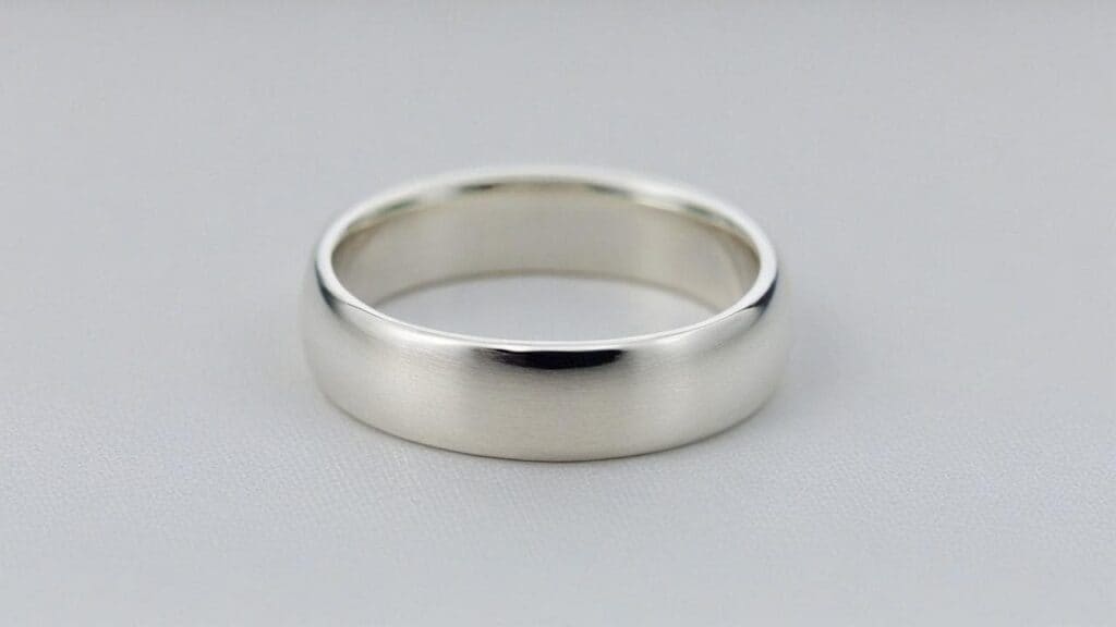 Simple Argentium Silver wedding ring band with bright white finish demonstrating tarnish-resistant properties