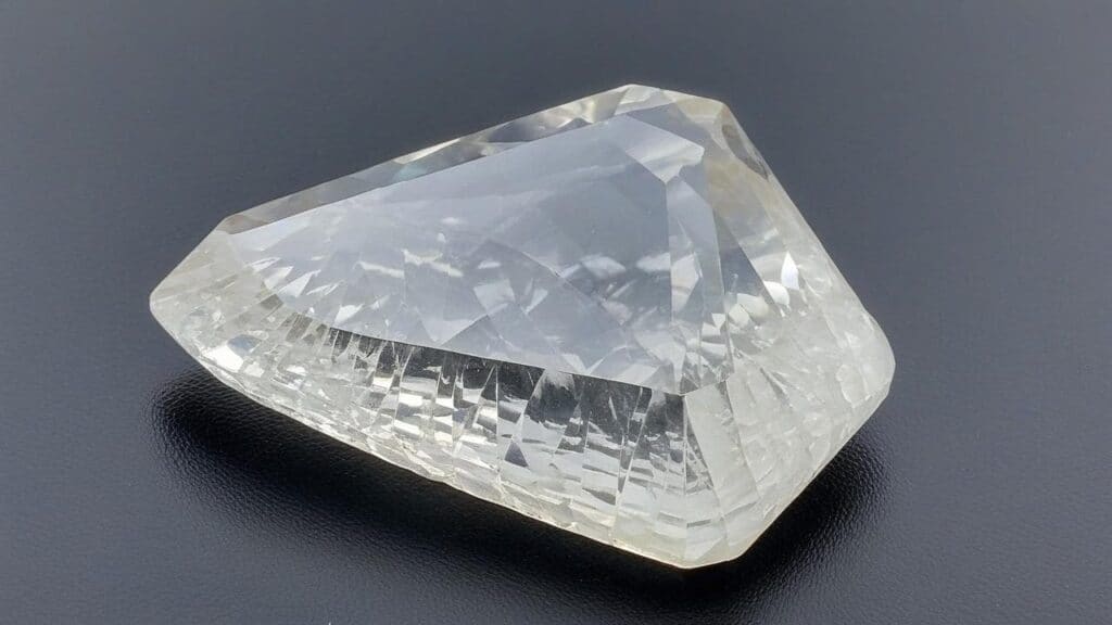 Transparent pear cut barite gemstone showing brilliant facets and exceptional clarity, representing the colorless variety of this mineral