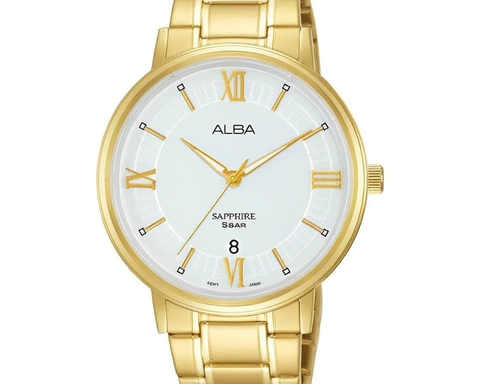 Alba dress watch with gold tone case and bracelet, white dial featuring Roman numerals, sapphire crystal and date display at 6 o'clock