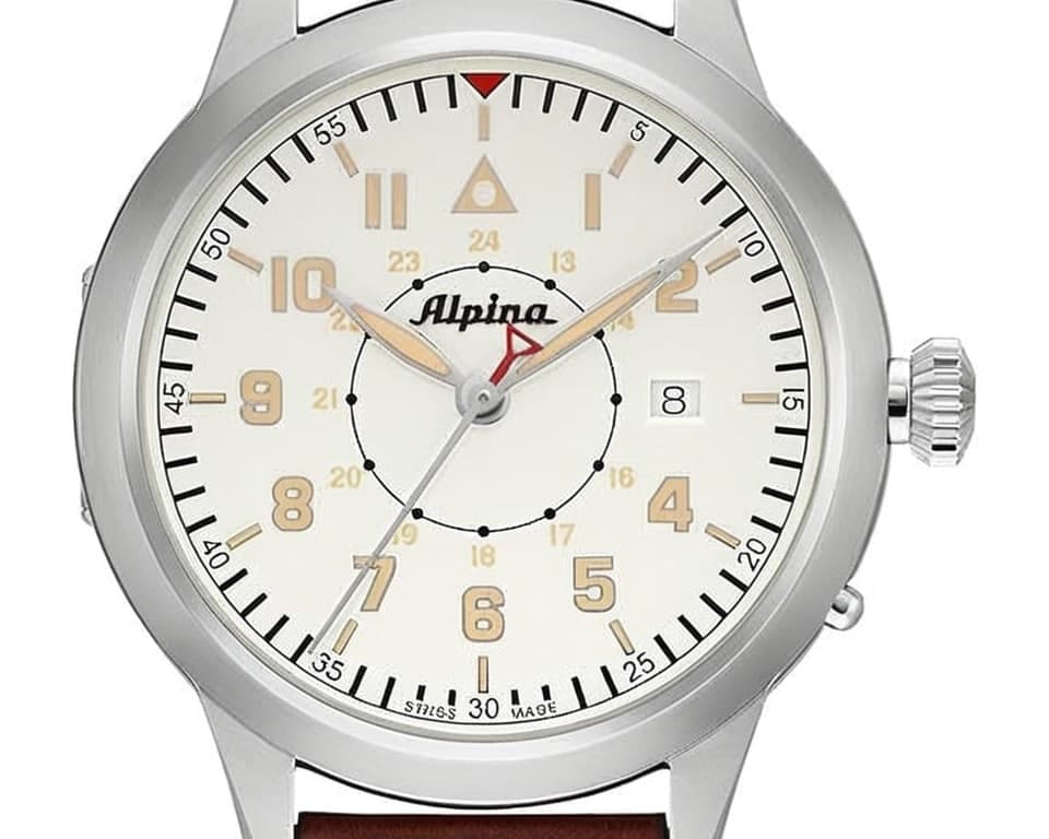 Alpina Startimer Pilot Heritage watch with cream white dial, red triangle logo, Arabic numerals, stainless steel case and brown leather strap showcasing Swiss aviation timepiece design