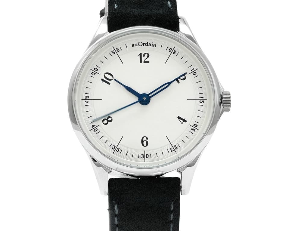 anOrdain Model 1 with white enamel dial and blue hands on a black leather strap