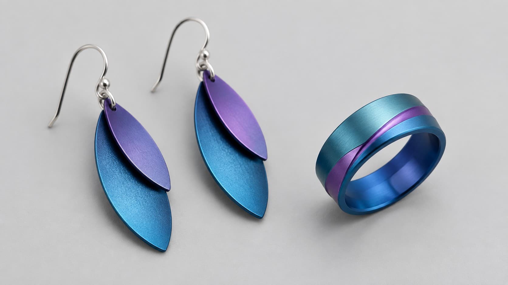 Blue and purple anodized aluminum earrings and ring showing the color anodizing adds to aluminum jewelry