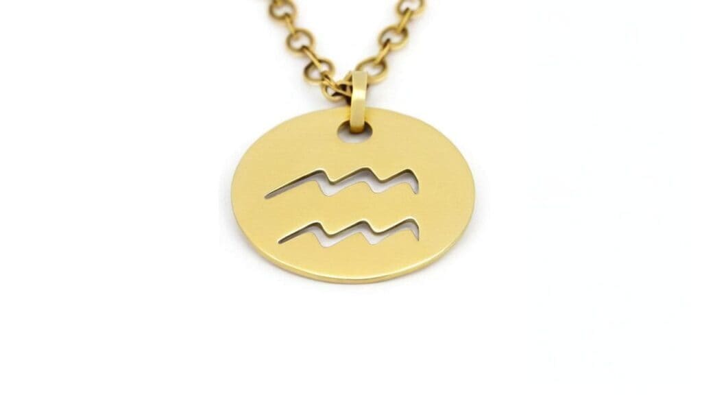 Gold circular Aquarius zodiac pendant necklace showing distinctive wavy symbol pattern on round disc
