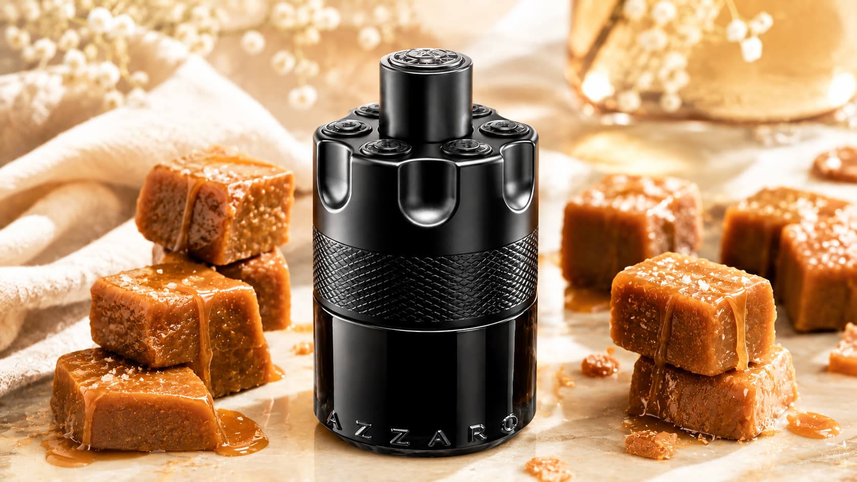 Azzaro The Most Wanted perfume bottle surrounded by toffee and caramel