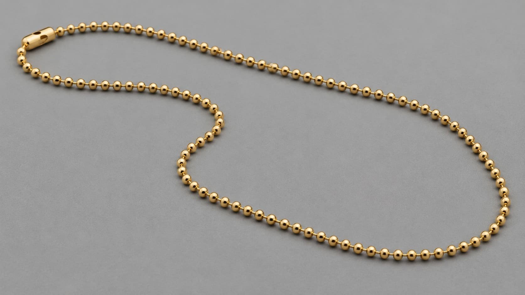 Gold bead chain necklace, also called a ball chain, made of small connected spheres