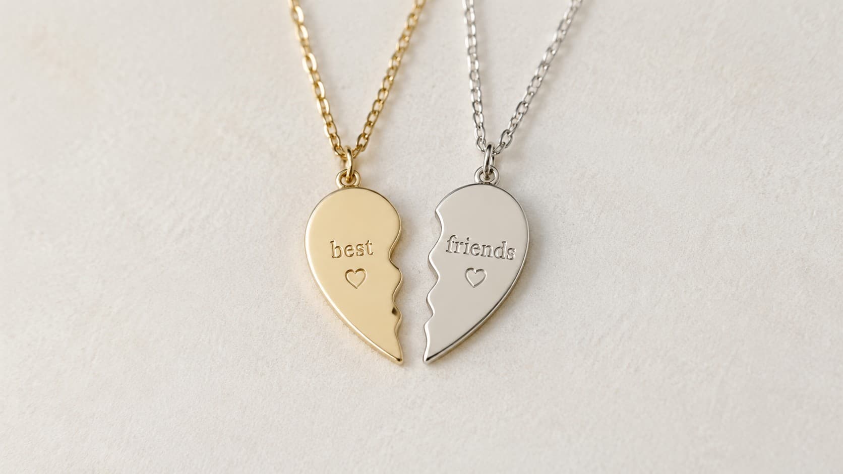 Matching gold and silver heart pendant necklaces engraved with the words best and friends