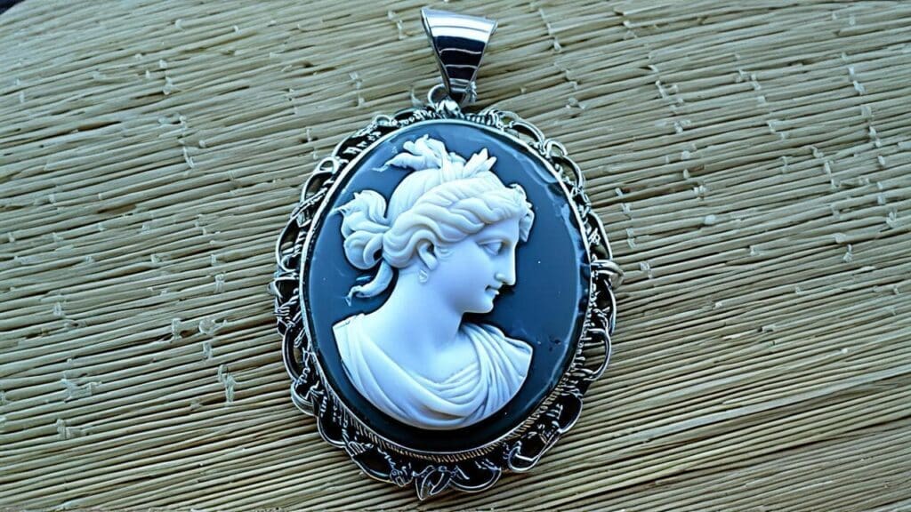 Black and white cameo pendant featuring a female profile carved in high relief against a dark background