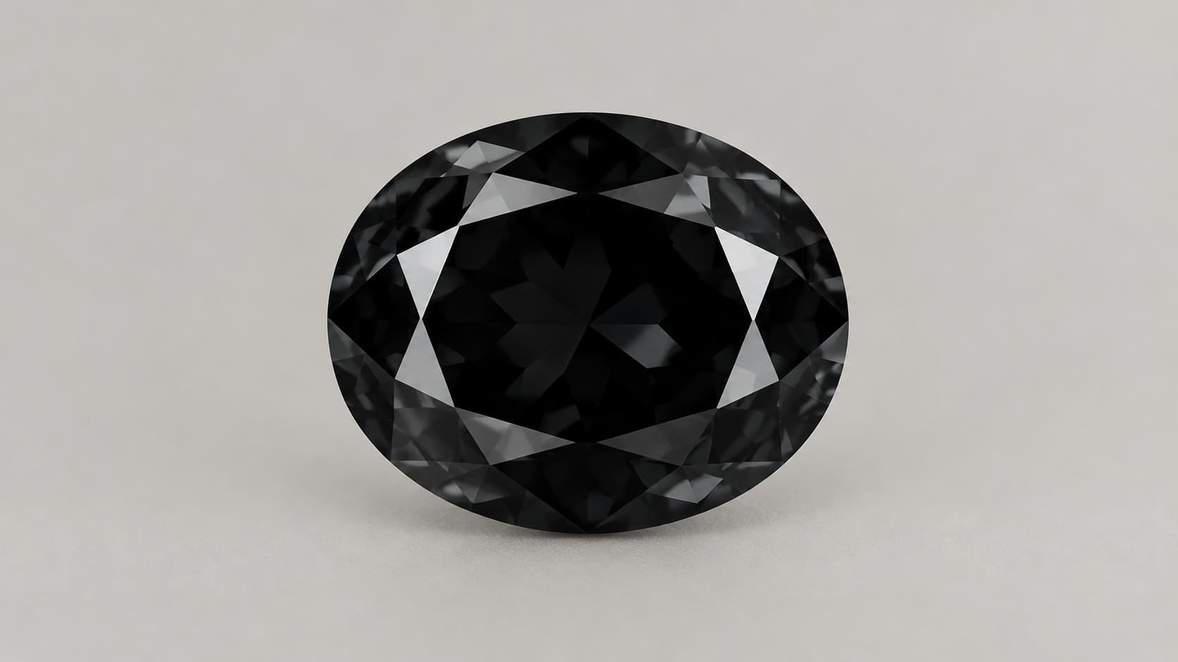 Oval cut black diamond gemstone with a metallic luster against a neutral grey background