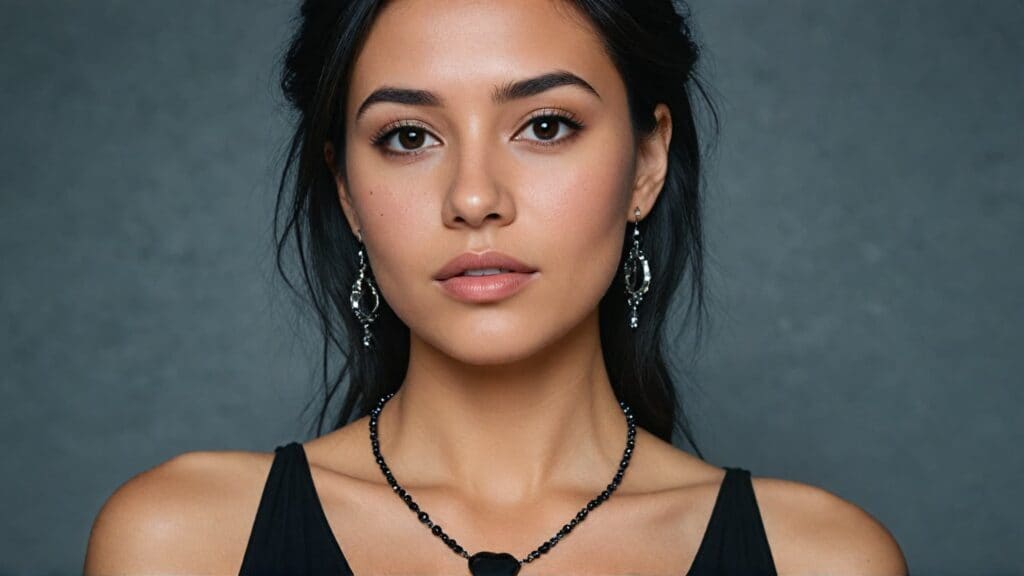 Woman in black dress wearing black onyx necklace and chandelier earrings for semi-formal evening event