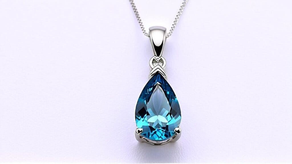 Teardrop-shaped blue topaz pendant set in silver with delicate chain, highlighting an affordable alternative to aquamarine in fine jewelry.