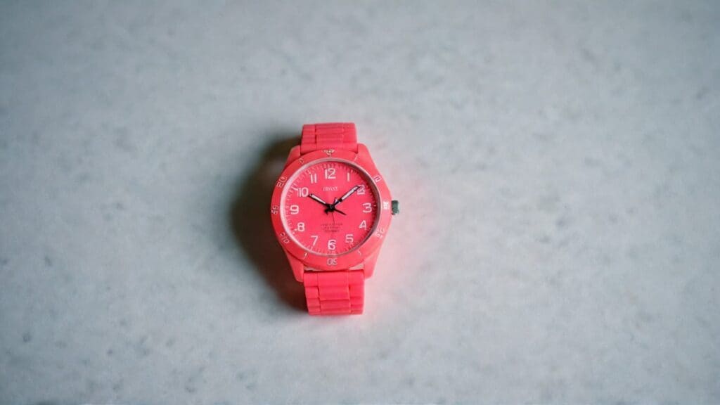 Bright red analog watch with large clear numbers and rotating bezel, perfect educational timepiece for children learning to tell time