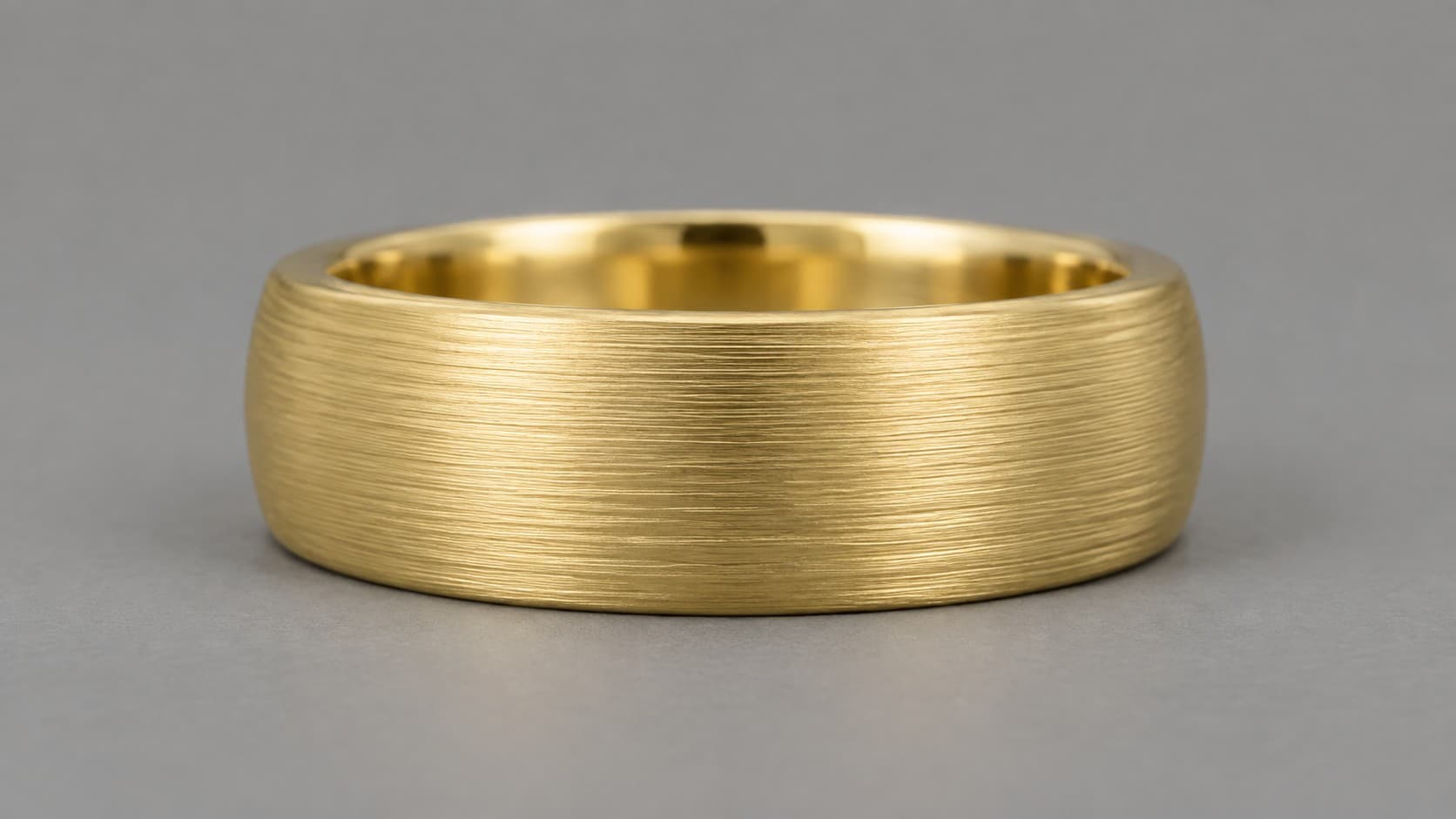 Gold ring with a brushed linear texture finish