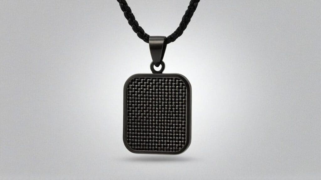 Square carbon fiber pendant on black cord showing intricate woven pattern
