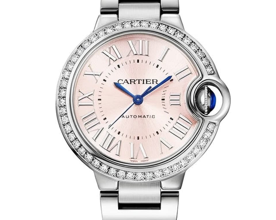 Cartier Ballon Bleu watch with diamond-set bezel, pink mother-of-pearl dial, and stainless steel bracelet featuring automatic movement
