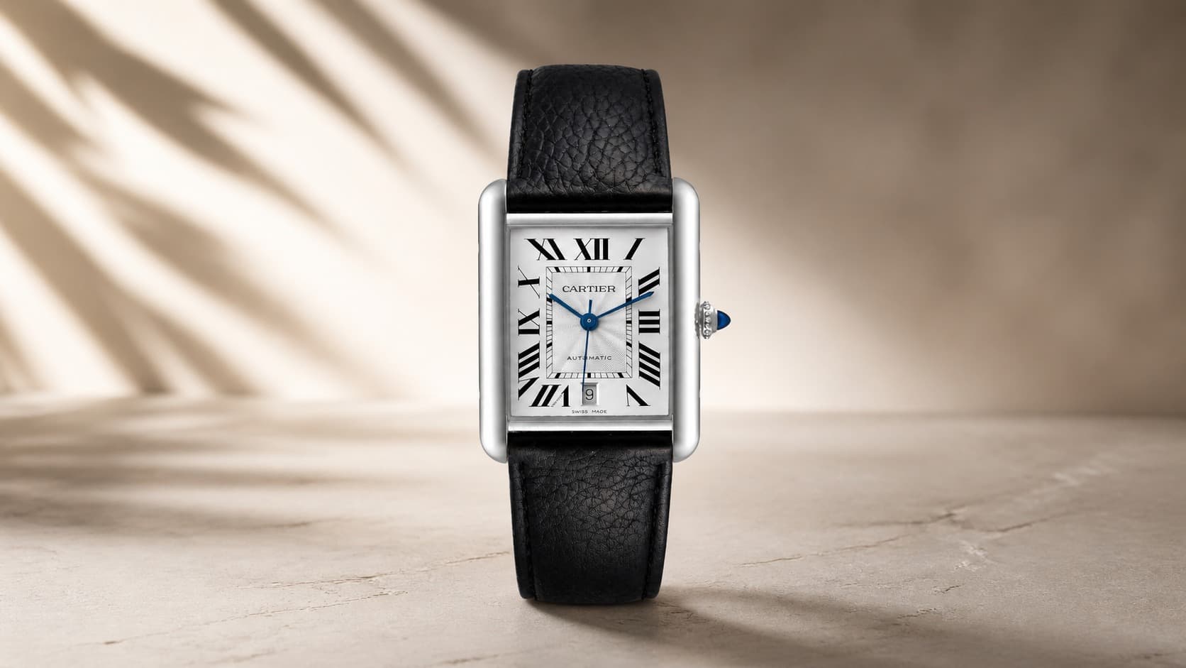 Cartier Tank Must in steel with a black leather strap and Roman numeral dial