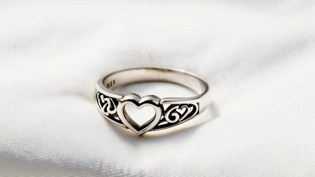Silver purity ring featuring an open heart and Celtic-style scrollwork, symbolizing love, purity, and inner strength