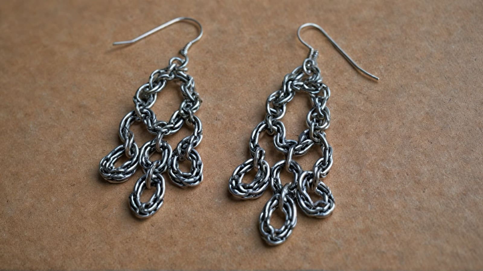 Silver chainmaille dangle earrings with linked teardrop loops on hooks