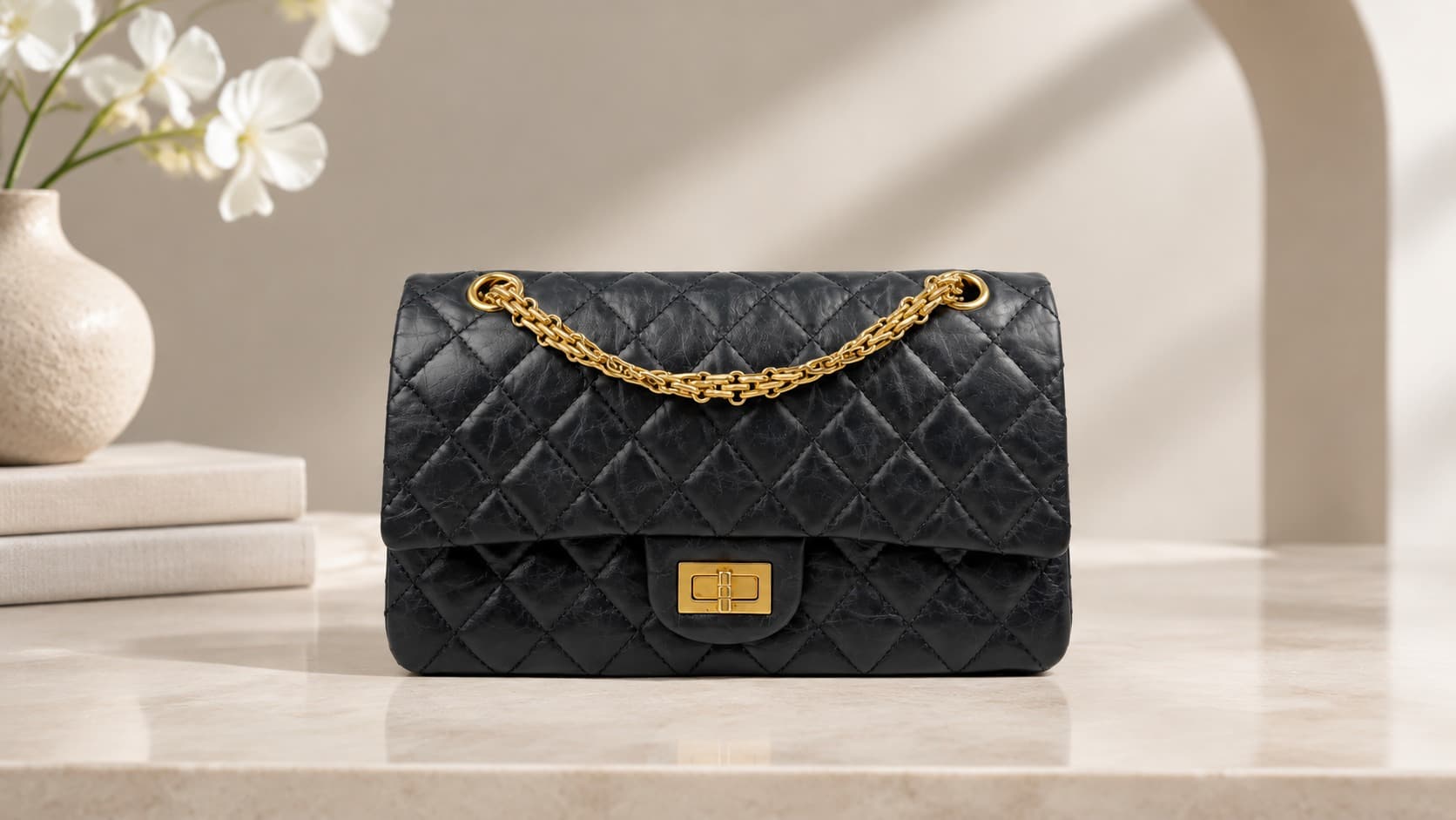 Black quilted Chanel 2.55 flap bag with gold chain strap from the 1950s