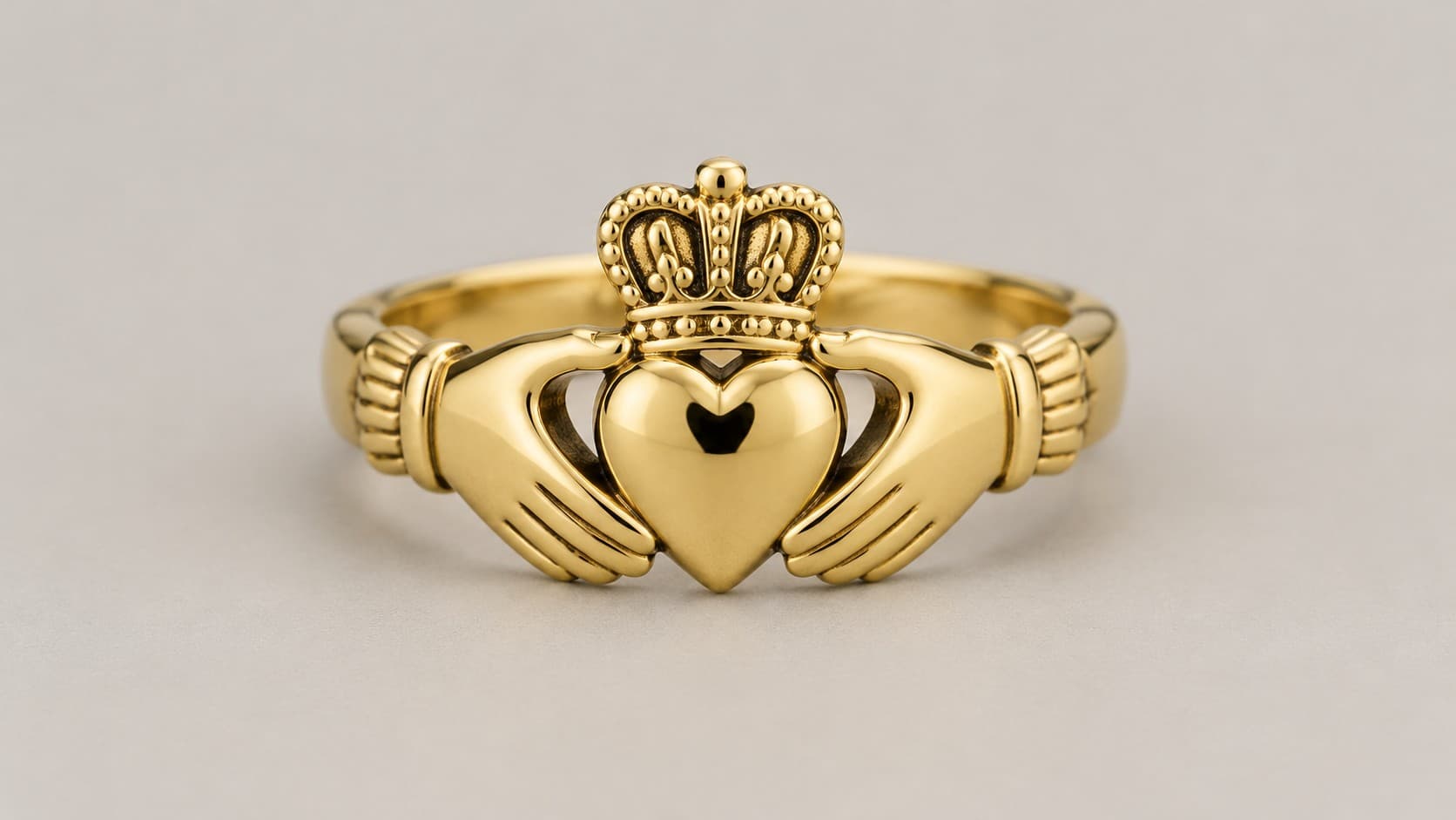 Yellow gold Claddagh ring featuring the traditional heart, hands, and crown design