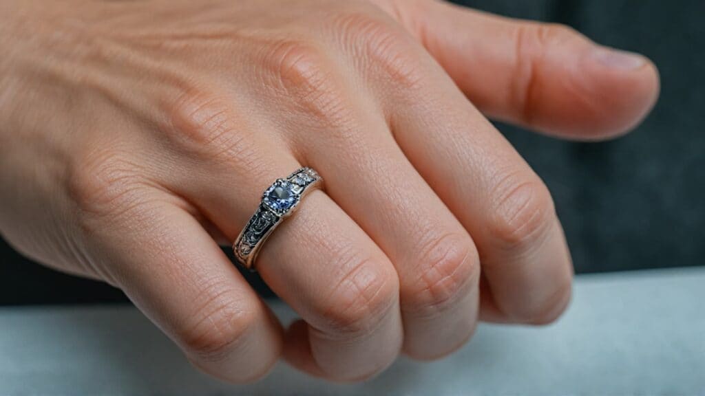 Close-up of a hand wearing a diamond ring with proper fit, showing how jewelry should look when sized correctly for comfort