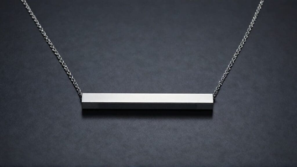 A sleek cobalt bar necklace with a minimalist design, featuring a polished finish and a silver chain on a dark background.