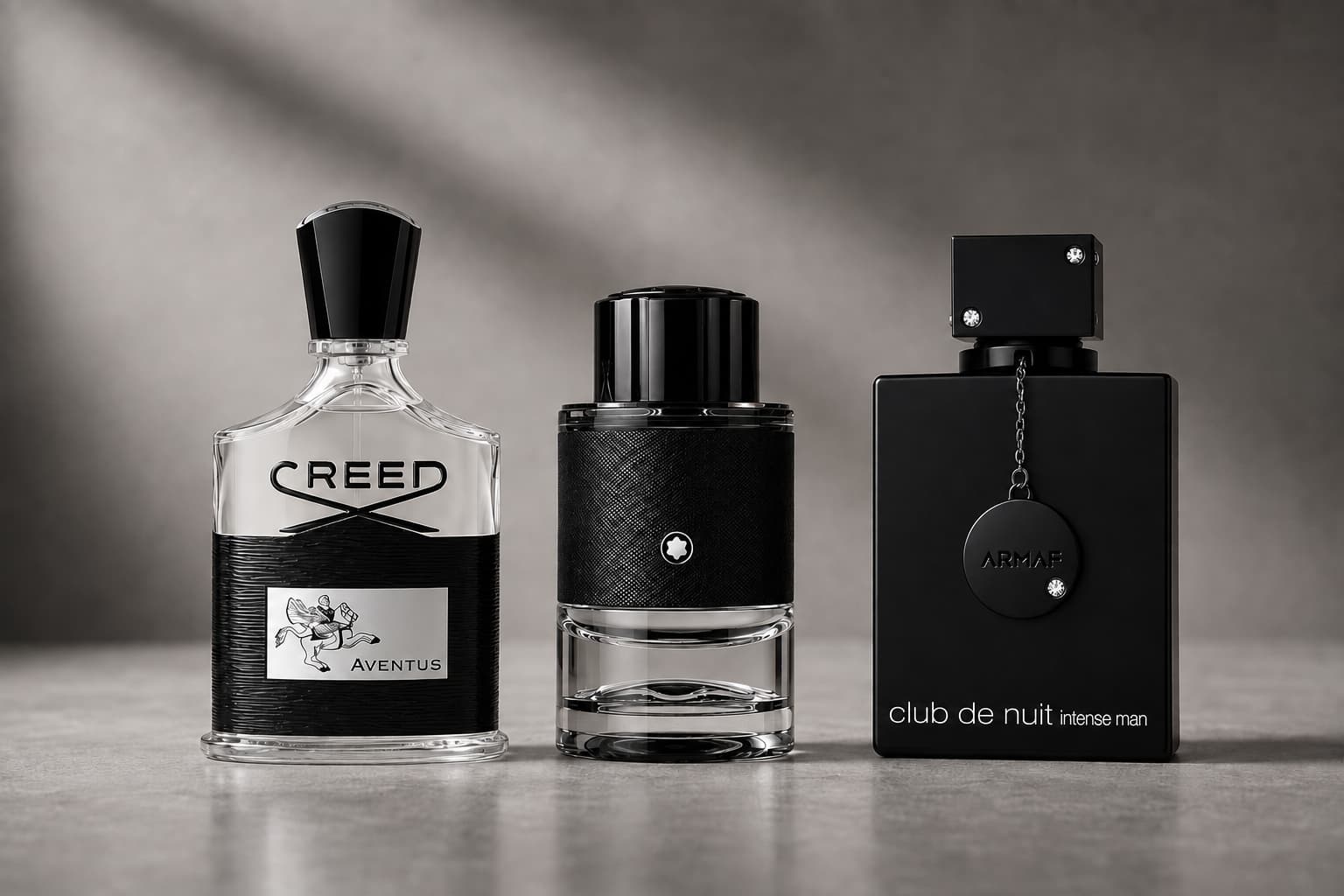 Creed Aventus, Montblanc Explorer, and Armaf Club de Nuit Intense Man perfume bottles