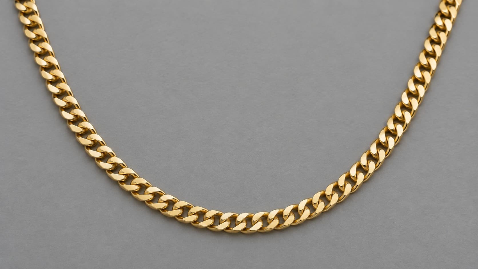 Gold curb chain necklace with flattened interlocking links