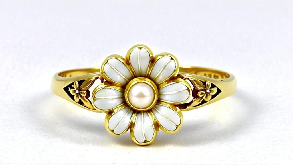 Gold daisy ring featuring white enamel petals, pearl center, and decorative floral band design