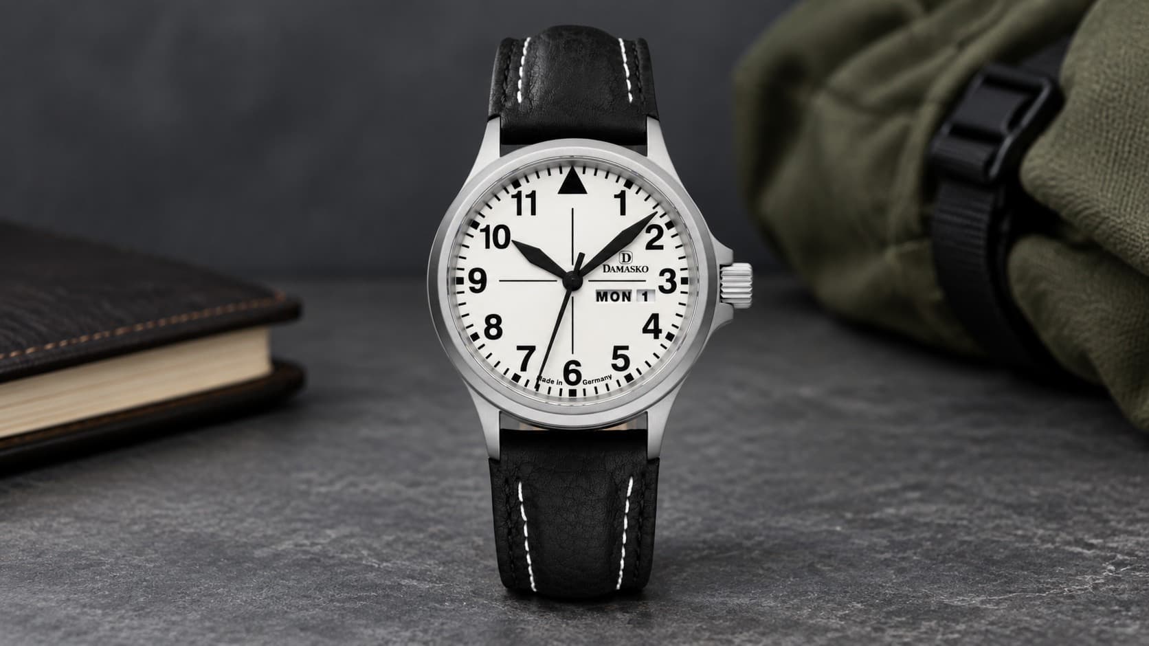 Damasko DK37 pilot watch with a white dial, day-date window, and black leather strap