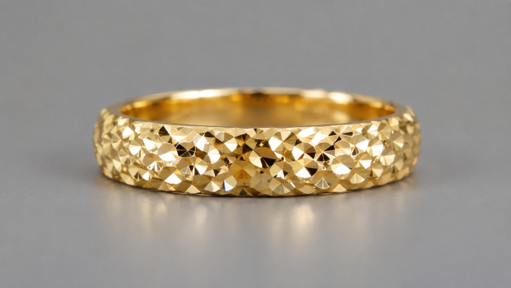 Gold ring with a sparkling diamond-cut faceted finish