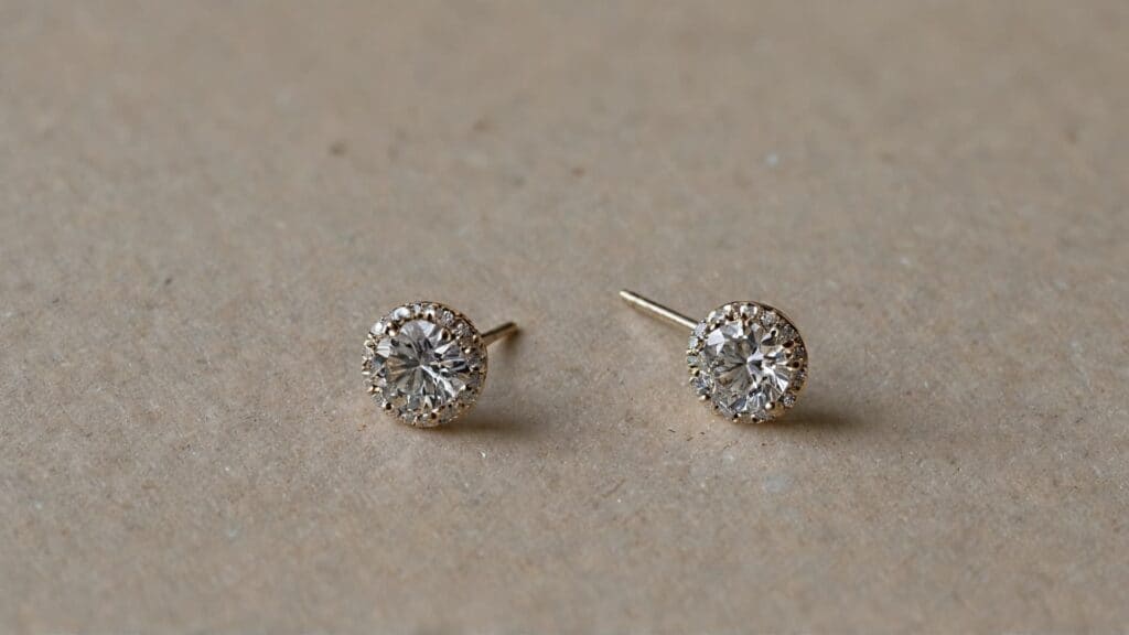 Diamond stud earrings showing bent earring post, demonstrating common earring security problems that cause loss