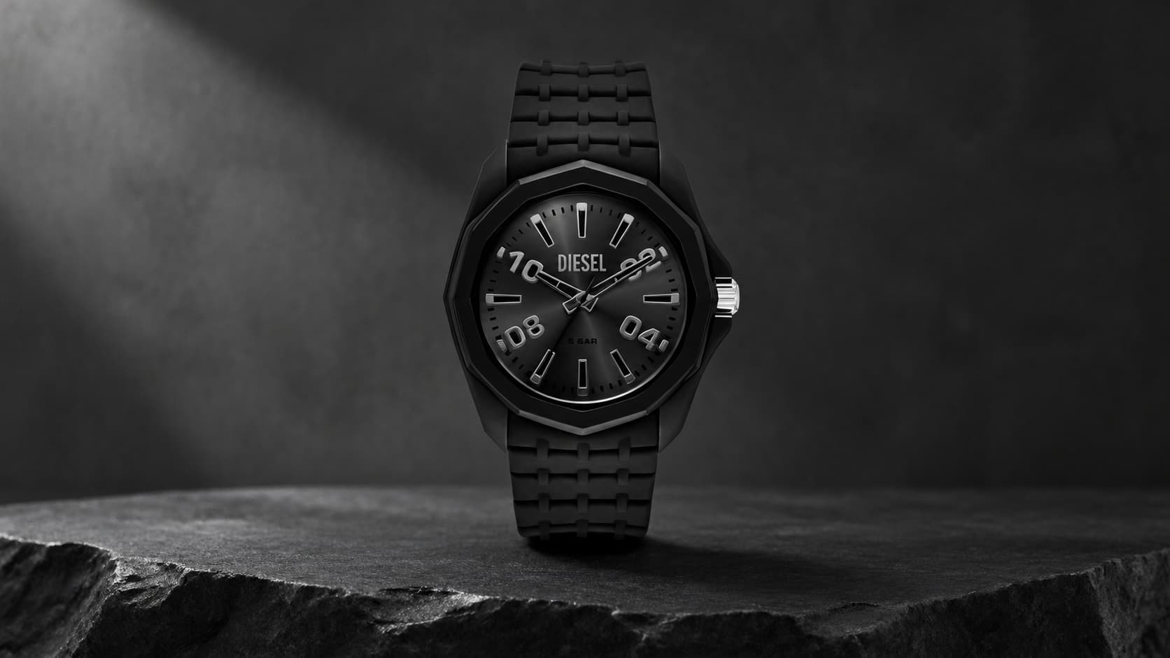 Diesel Stinger black silicone watch with black dial on dark background