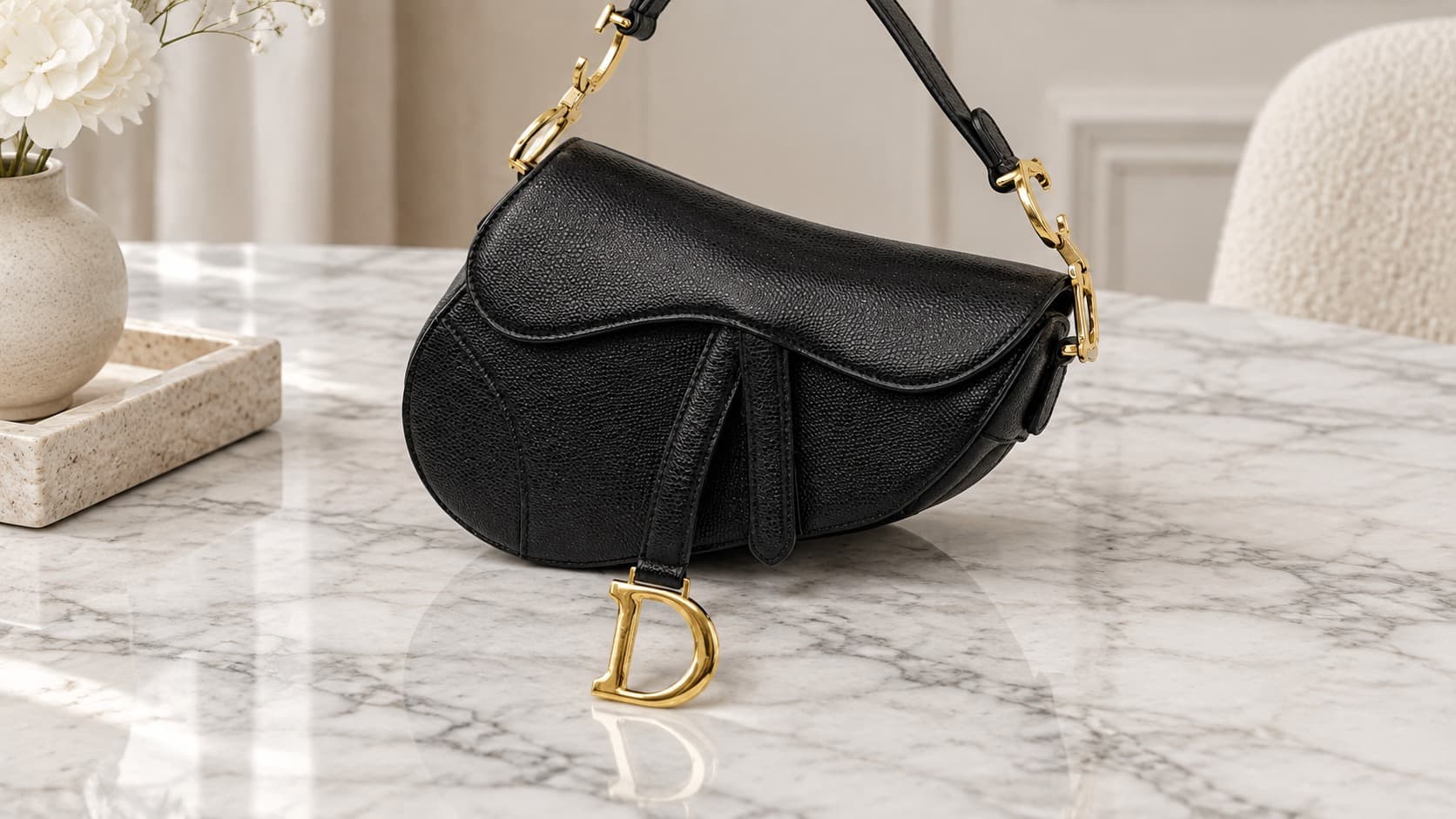 Black Dior Saddle bag with gold hardware, an iconic 2000s It bag