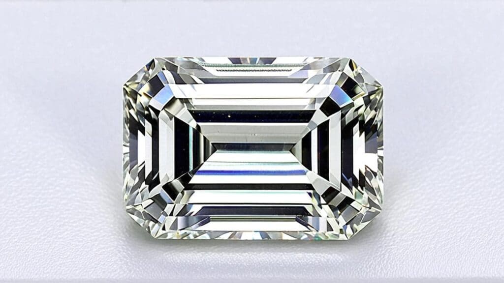 A dazzling emerald-cut diamond with precise step-cut facets, reflecting light beautifully.