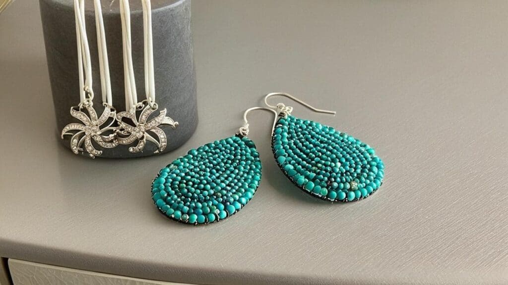High-value turquoise earrings and silver necklace demonstrating need for jewelry insurance riders on renters policy