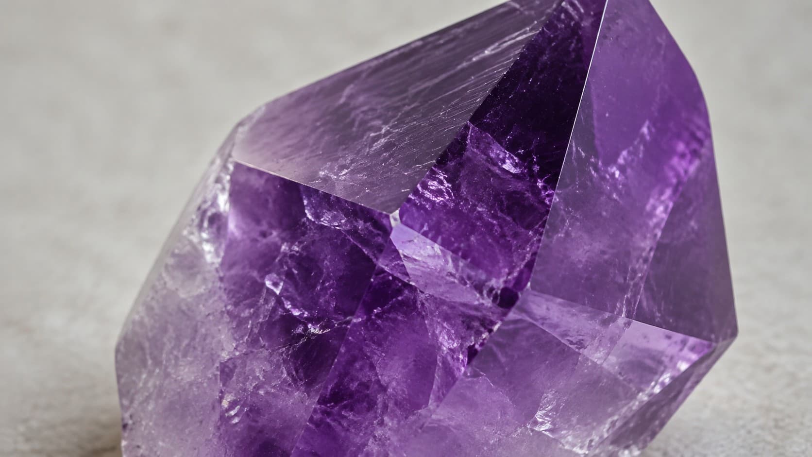 Raw amethyst crystal point showing natural purple color