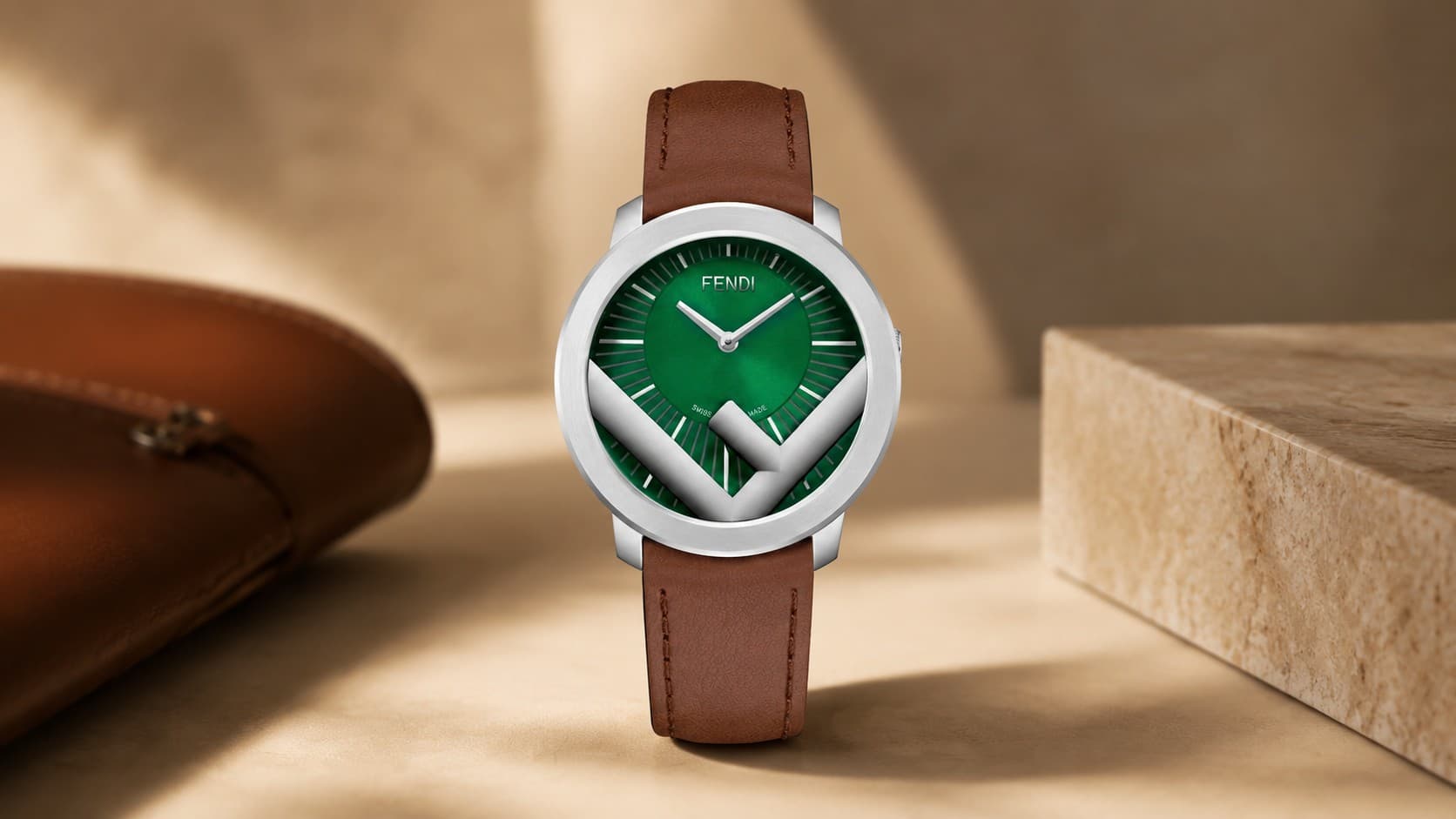 Fendi Run Away watch with a green dial, stylized F logo, and brown leather strap
