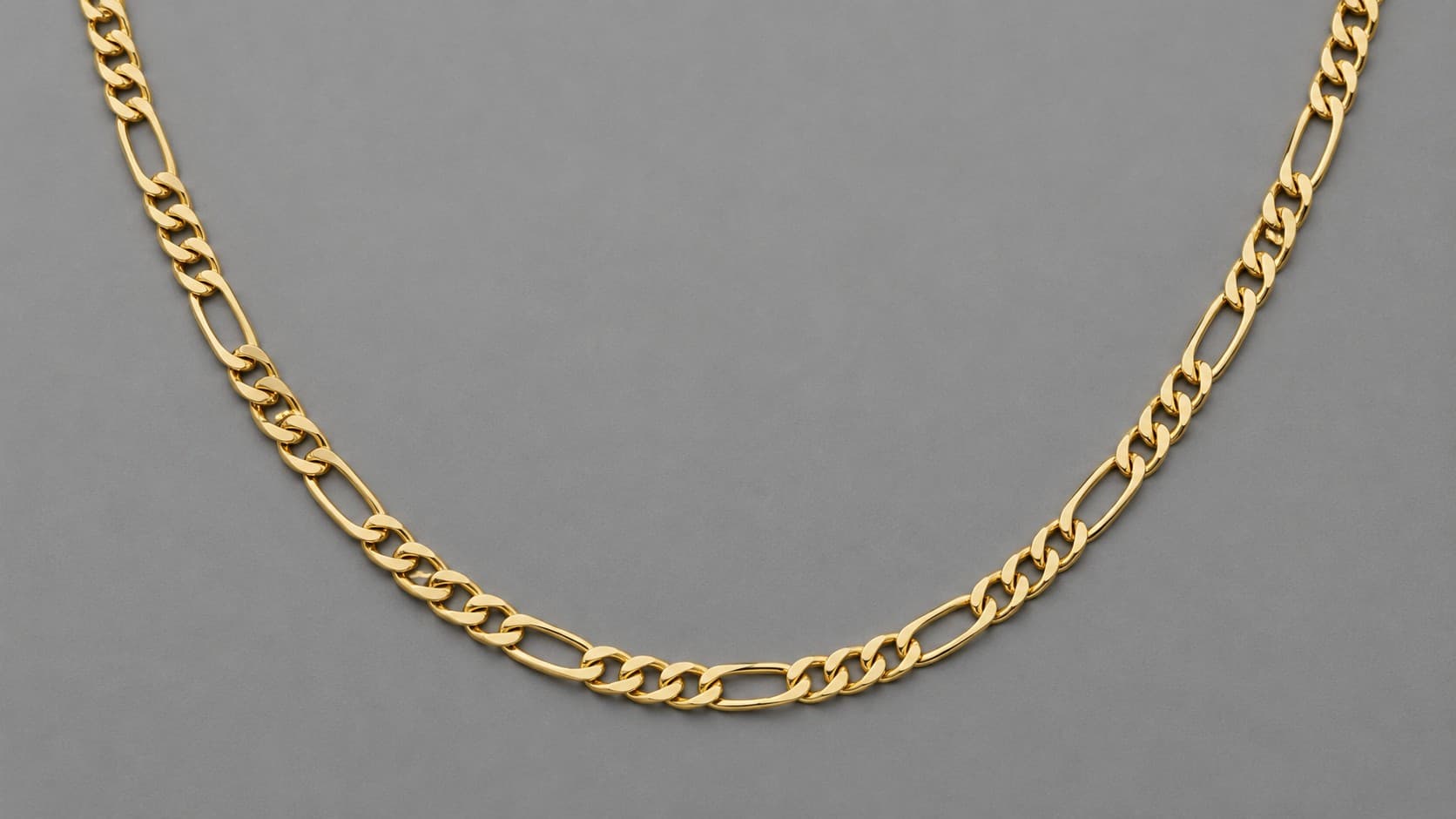 Gold figaro chain necklace with alternating long and short links